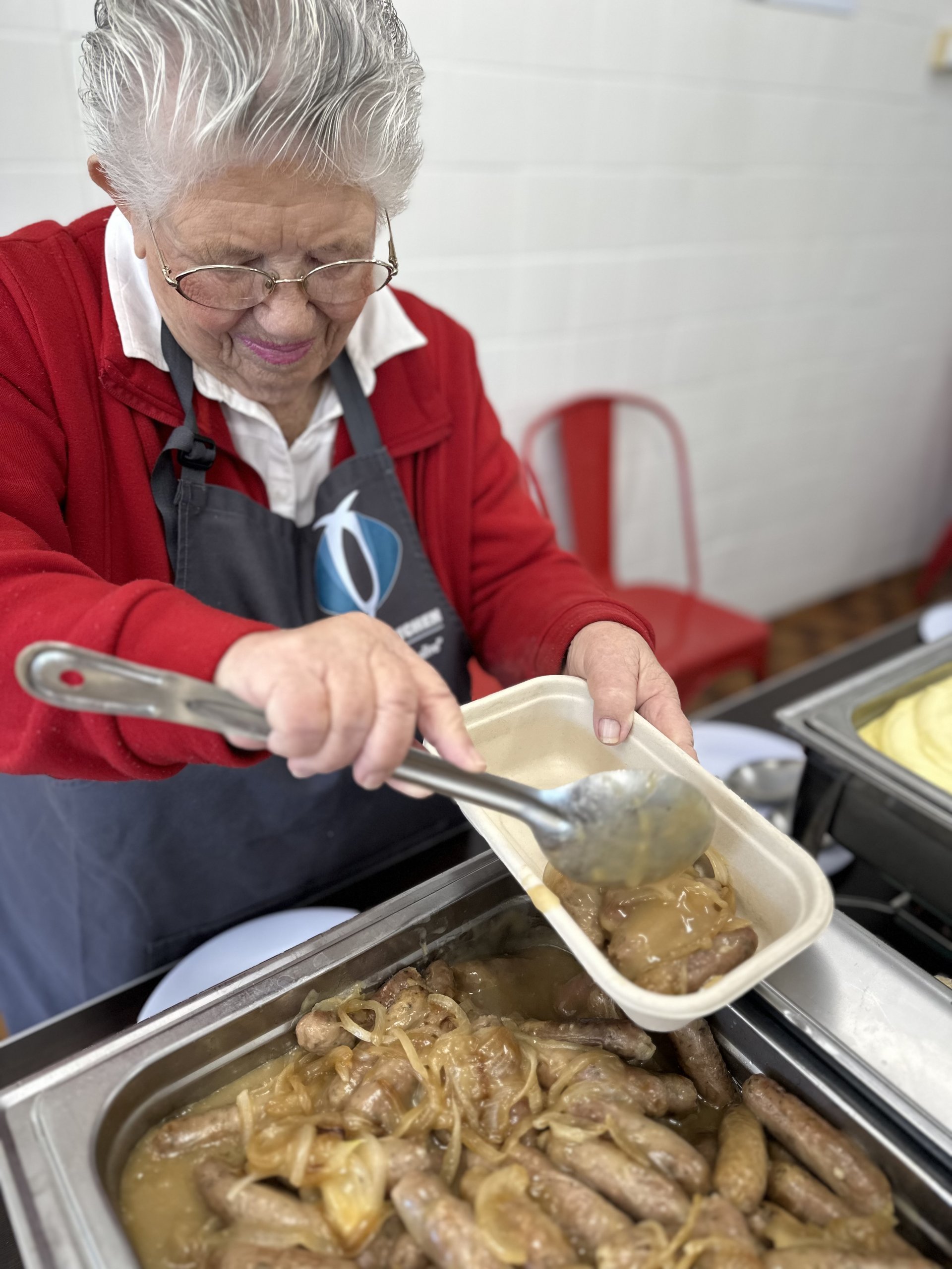 Volunteer serving meals at Oakdene Kitchen