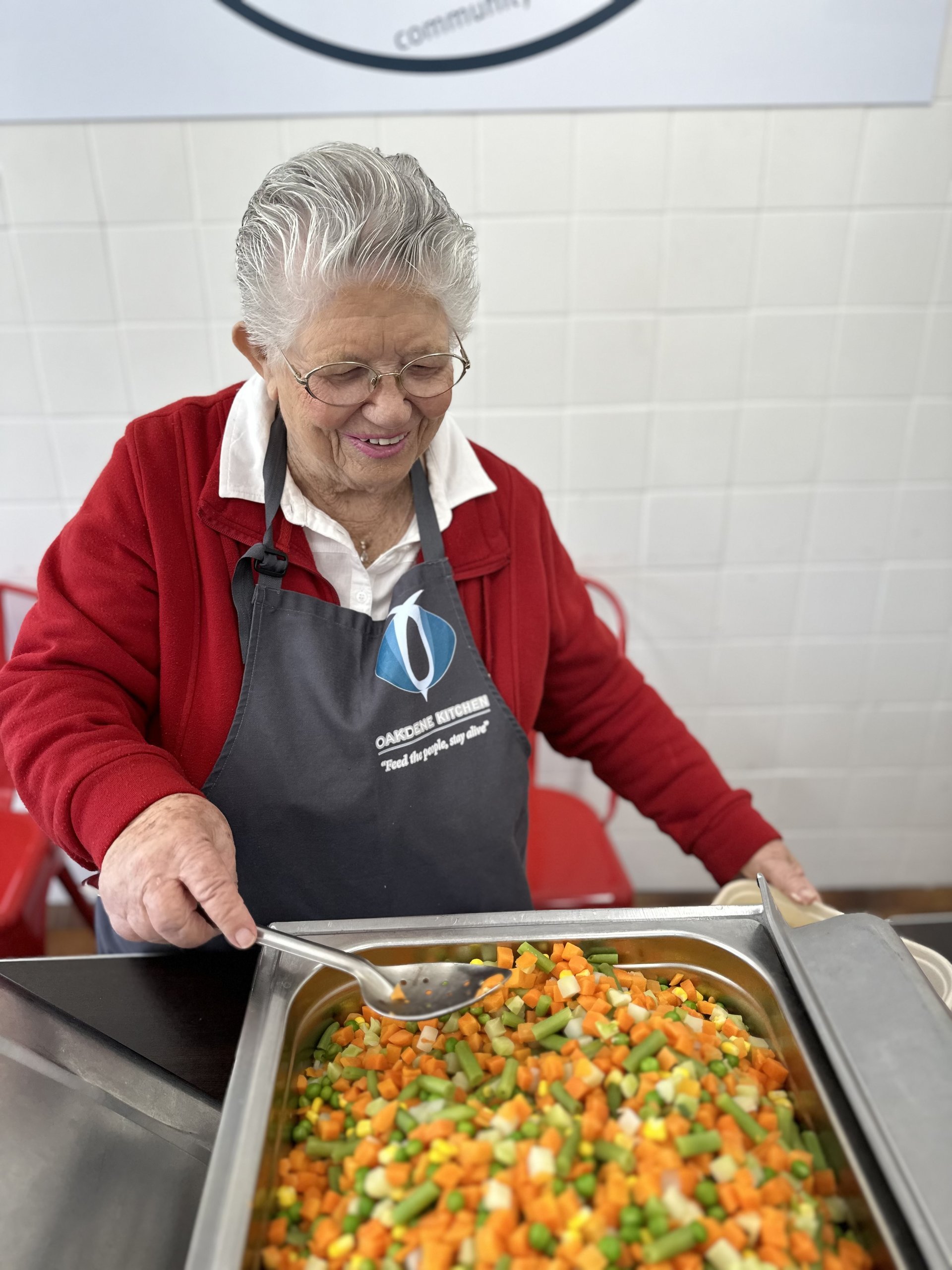 Volunteer serving food at Oakdene Kitchen